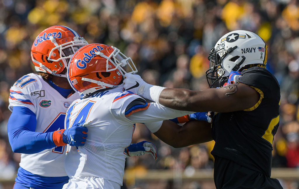 Florida defenders James Houston IV and Quincy Lenton grapple with Missouri's Jamal Brooks